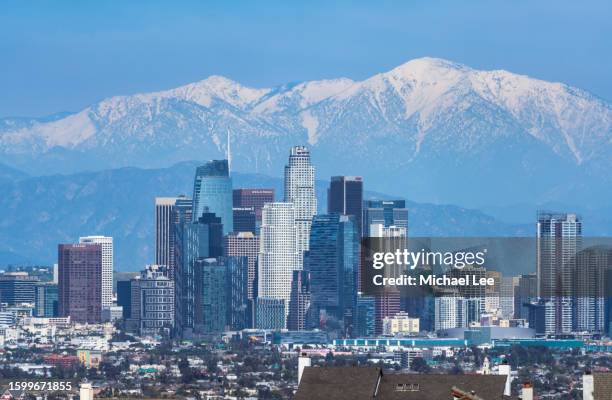 downtown los angeles skyline and snow capped mountains - san gabriel mountains stock pictures, royalty-free photos & images