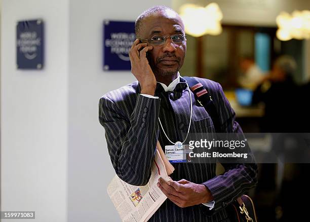 Lamido Sanusi, governor of the Central Bank of Nigeria, talks on his mobile phone in between sessions on day two of the World Economic Forum in...
