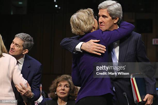 Sen. John Kerry embraces Sen. Elizabeth Warren after she introduced him during his confirmation hearing before the Senate Foreign Relations Committee...
