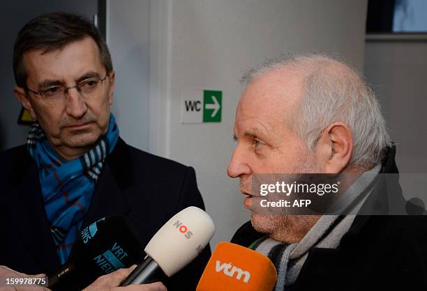 Former Rabobank team doctor Geert Leinders looks at his lawyer Johnny Maeschalck who speaks to journalists after a hearing of the Belgian Royal...