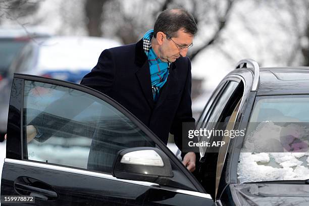Former Rabobank team doctor Geert Leinders enters a car after a hearing of the Belgian Royal Cycling Association in Brussels, on January 24, 2013....