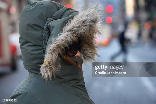 Pedestrian bundled up against the cold walks through the streets of Manhattan on January 24, 2013 in New York City. Polar air settled in over the...