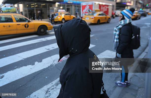 Pedestrians bundled up against the cold walk through the streets of Manhattan on January 24, 2013 in New York City. Polar air settled in over the...