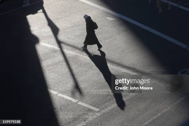 Pedestrian bundled up against the cold walks through the streets of Manhattan on January 24, 2013 in New York City. Polar air settled in over the...