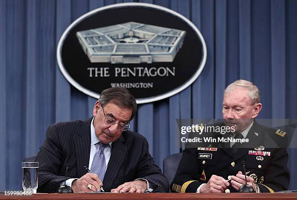 Defense Secretary Leon Panetta and Chairman of the Joint Chiefs of Staff General Martin Dempsey sign orders that will lift the ban on women in combat...