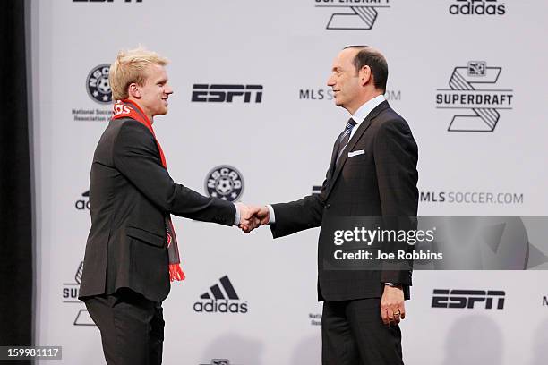 Kyle Bekker of Boston College shakes hands with commissioner Don Garber after being selected by Toronto FC as the third overall pick in the 2013 MLS...