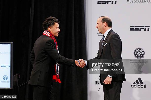 Carlos Alvarez of Connecticut shakes hands with commissioner Don Garber after being selected by Chivas USA as the second overall selection in the...