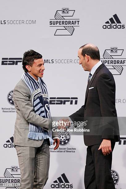 Mikey Lopez of North Carolina shakes hands with commissioner Don Garber after being selected by Sporting Kansas City as the 14th overall pick in the...