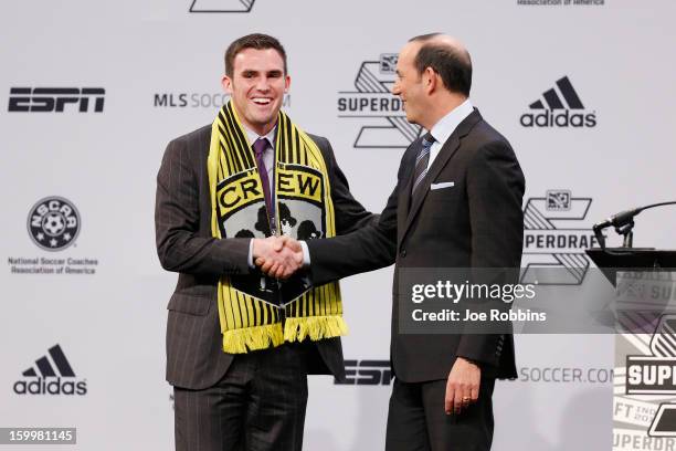 Ryan Finley of Notre Dame shakes hands with commissioner Don Garber after being selected by the Columbus Crew as the ninth overall pick in the 2013...