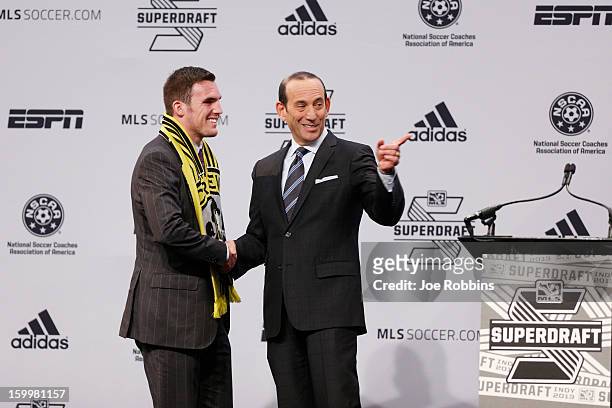 Ryan Finley of Notre Dame shakes hands with commissioner Don Garber after being selected by the Columbus Crew as the ninth overall pick in the 2013...