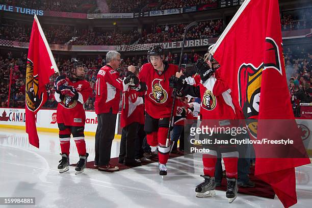 Kyle Turris of the Ottawa Senators steps onto the ice during player introductions of the home opener prior to playing an NHL game against the Florida...