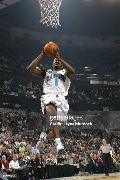 Baron Davis of the New Orleans Hornets dunks the ball during the NBA game against the Utah Jazz at New Orleans Arena on October 30, 2002 in New...