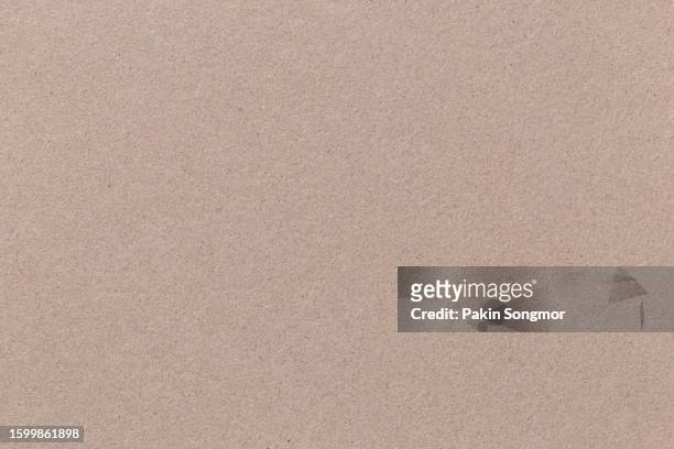 brown color eco recycled kraft paper sheet texture cardboard background. - kraft paper stockfoto's en -beelden