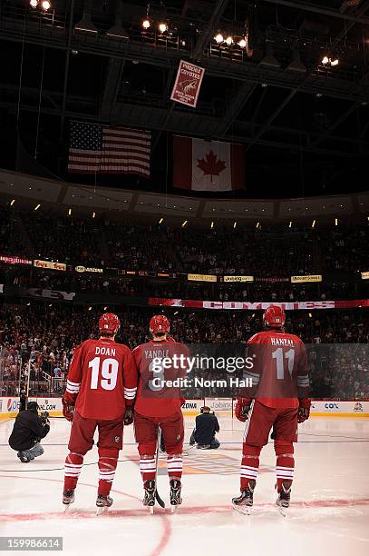 Martin Hanzal, Keith Yandle and Shane Doan of the Phoenix Coyotes watch the unveiling of the 2011-2012 Pacific Division Championship banner prior to...