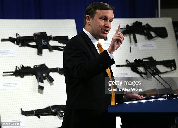 Senator Chris Murphy speaks next to a display of assault weapons during a news conference January 24, 2013 on Capitol Hill in Washington, DC. U.S....