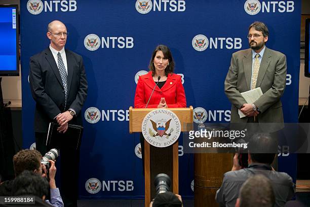 Deborah Hersman, chairman of the National Transportation Safety Board , center, speaks during a news conference with John DeLisi, director of...