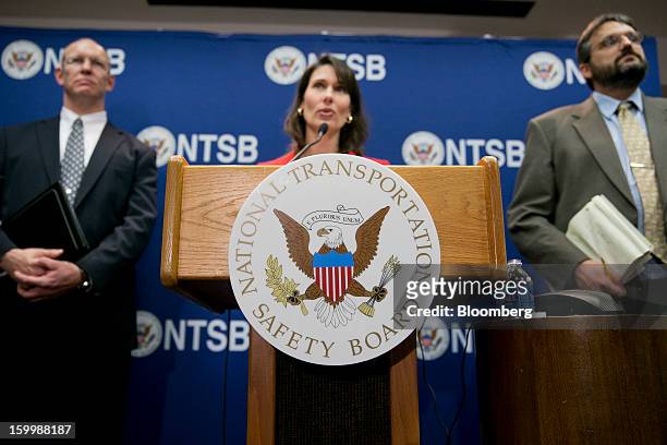 Deborah Hersman, chairman of the National Transportation Safety Board , center, speaks during a news conference with John DeLisi, director of...