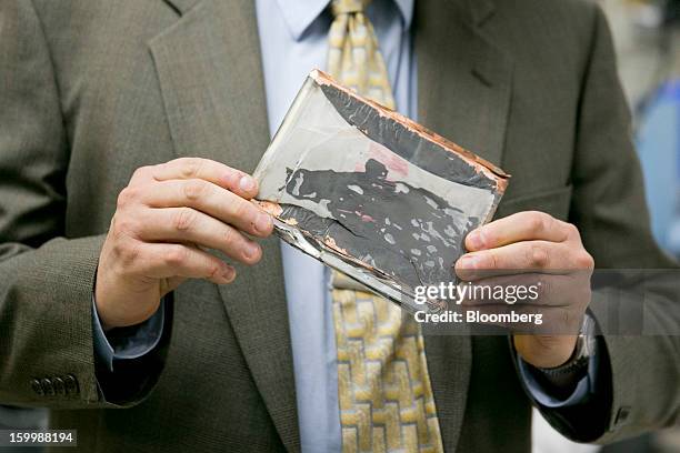 Joseph Kolly, director of research and engineering with the National Transportation Safety Board , holds a damaged electrode from a Japan Airlines...