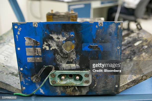 Damaged battery case from a Japan Airlines Co. Boeing Co. 787 Dreamliner sits at the National Transportation Safety Board materials laboratory in...