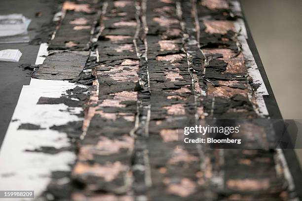 An uncoiled damaged battery electrode from a Japan Airlines Co. Boeing Co. 787 Dreamliner sits at the National Transportation Safety Board materials...