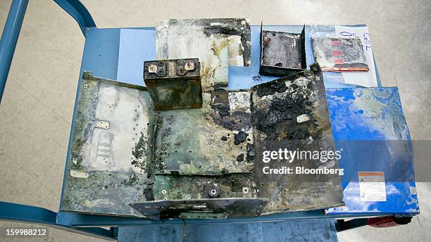 Damaged battery case from a Japan Airlines Co. Boeing Co. 787 Dreamliner sits at the National Transportation Safety Board materials laboratory in...