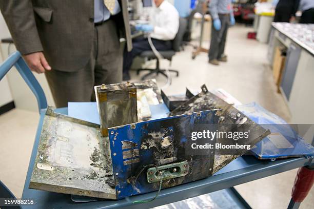 Damaged battery case from a Japan Airlines Co. Boeing Co. 787 Dreamliner sits at the National Transportation Safety Board materials laboratory in...