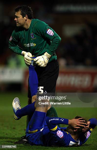 Neil Sullivan of AFC Wimbledon helps his team mate Chris Hussey during the npower League Two match between AFC Wimbledon and Port Vale at The Cherry...