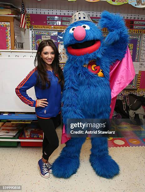 Knicks City Dancer Dominique and Sesame Street Live's Super Grover teach children from WHEDCo how to be super heroes on January 24, 2013 in New York...