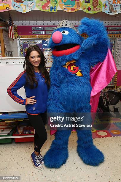 Knicks City Dancer Dominique and Sesame Street Live's Super Grover teach children from WHEDCo how to be super heroes on January 24, 2013 in New York...