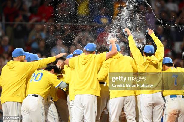 The Boston Red Sox celebrate after Pablo Reyes hit a walk-off grand slam against the Kansas City Royals during the ninth inning at Fenway Park on...