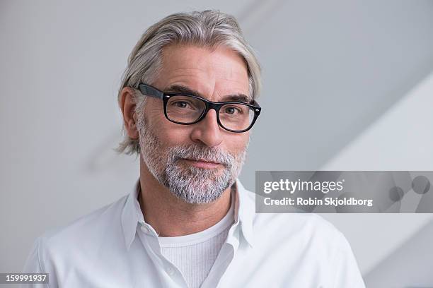 mature man with glasses and with shirt - white hair stock-fotos und bilder