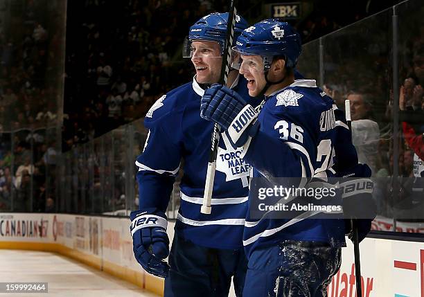 Carl Gunnarsson and Cody Franson of the Toronto Maple Leafs celebrate a Carl Gunnarsson goal against the New York Islanders during NHL action at the...