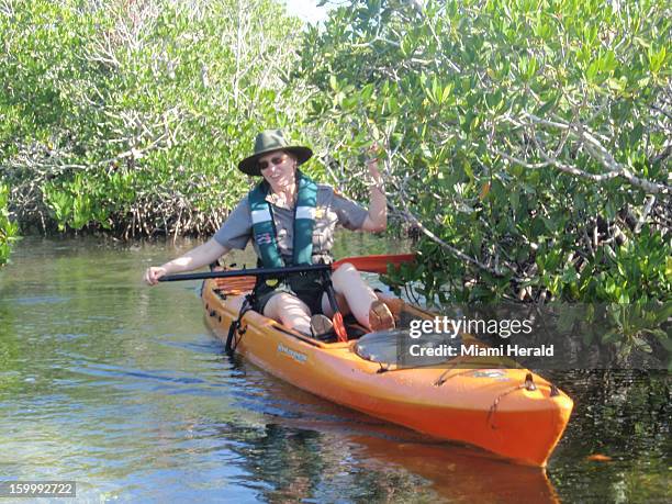 Christiana Admiral, chief of interpretation at Biscayne National Park, has to take her kayak paddle apart to navigate a narrow creek in the Biscayne...