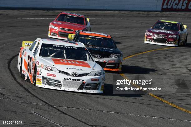 Race leader Jesse Love Venturini Motorsports TRD Toyota Camry is chased by William Sawalich Joe Gibbs Racing TRD Toyota Camry after they lap Isaac...