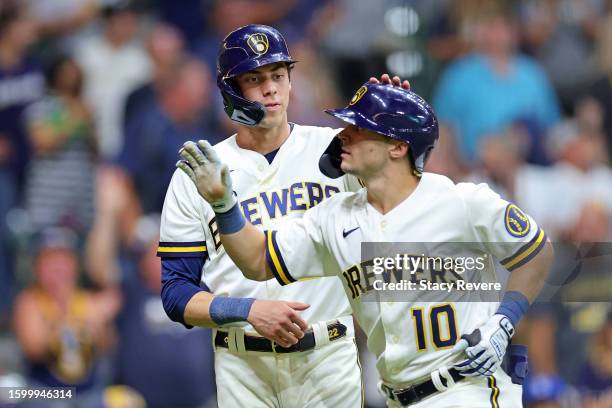 Sal Frelick of the Milwaukee Brewers is congratulated by Christian Yelich following a three run home run against the Colorado Rockies during the...