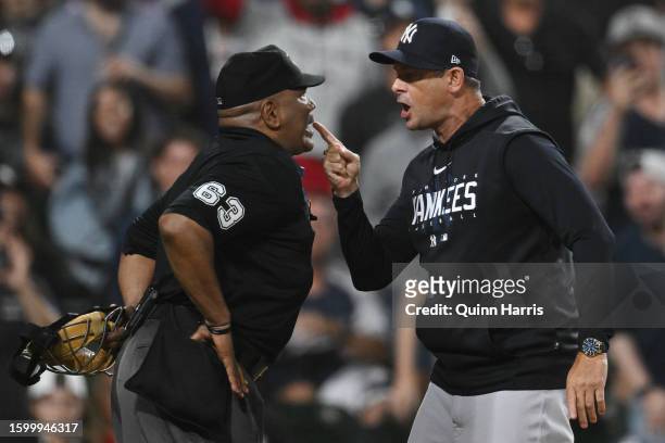 Home umpire Laz Diaz and manager Aaron Boone of the New York Yankees argue during the eight inning of the game against the Chicago White Soxat...