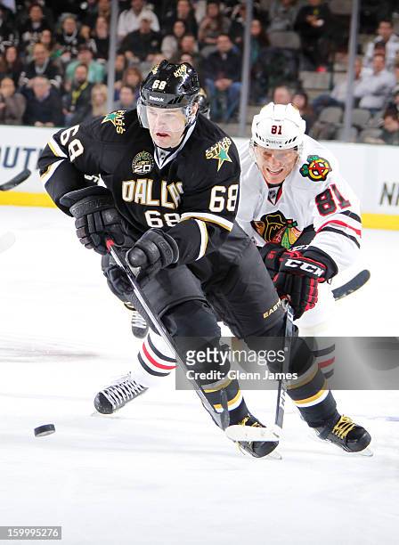 Jaromir Jagr of the Dallas Stars handles the puck against Marian Hossa of the Chicago Blackhawks at the American Airlines Center on January 24, 2013...