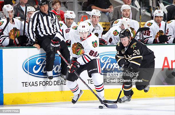 Patrick Kane of the Chicago Blackhawks handles the puck against Cody Eakin of the Dallas Stars at the American Airlines Center on January 24, 2013 in...