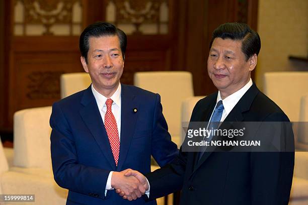 Natsuo Yamaguchi , leader of the Komeito party from Japan, shakes hands with China's president-in-waiting Xi Jinping during a meeting at the Great...