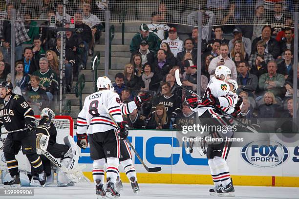 Patrick Kane and Marian Hossa of the Chicago Blackhawks celebrate an overtime game winning goal against the Dallas Stars at the American Airlines...