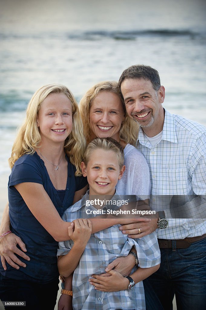 Portrait of family of four at the beach