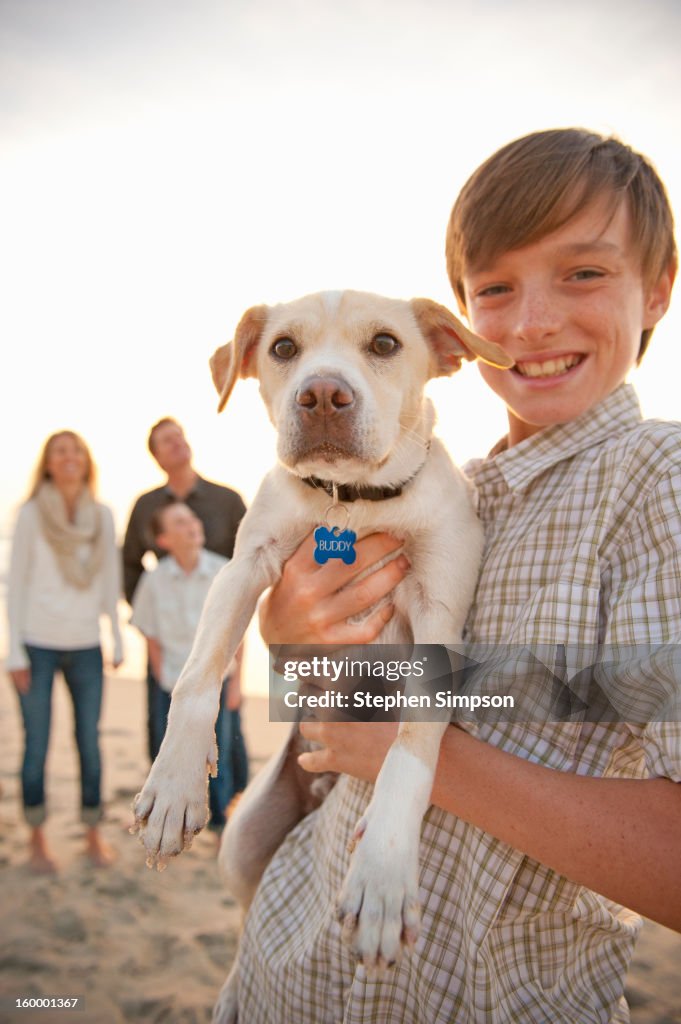 Portrait of a boy and his dog at the beach