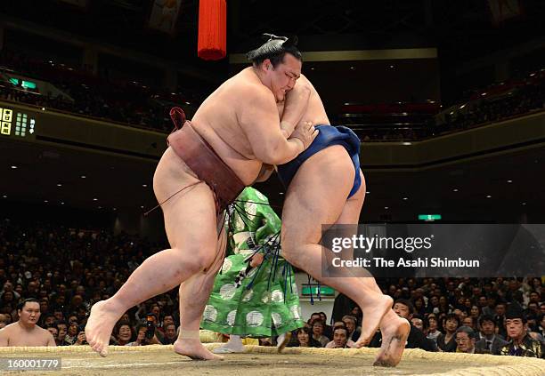 Ozeki Kisenosato and Mongolian ozeki Kakuryu, whose real name is Mangaljalavyn Anand compete during day 12 of the Grand Sumo New Year Tournament at...