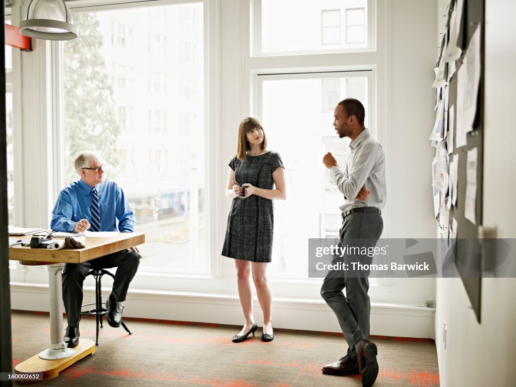 Coworkers in discussion in conference room