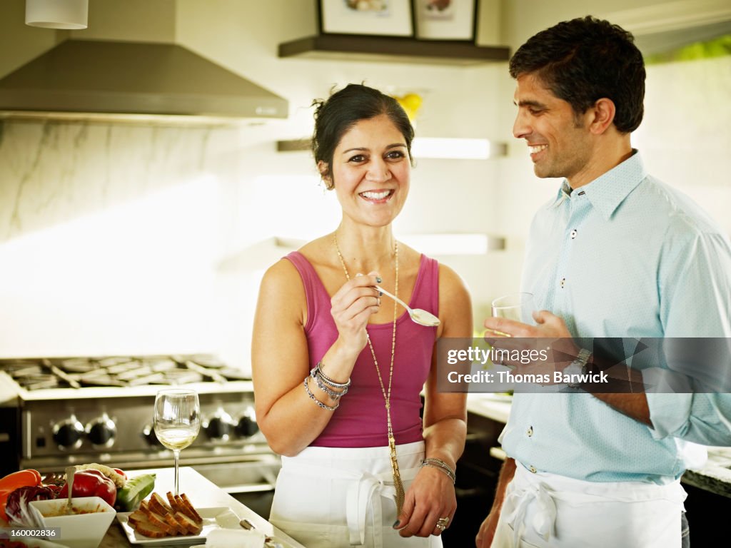 Husband and wife in kitchen preparing food