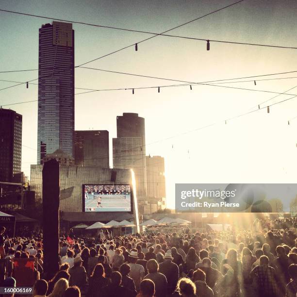 Huge crowds gather at Federation Square to watch the third round match between Bernard Tomic of Australia and Roger Federer of Switzerland during day...