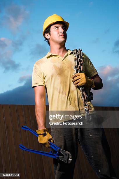 construction worker with bolt cutters and chain - bolt cutter stock pictures, royalty-free photos & images