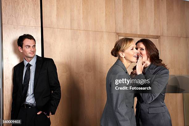 gossiping in business - male with group of females stock pictures, royalty-free photos & images