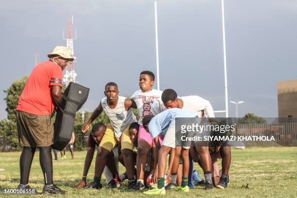 Coach Vuvu of the U16 Jabulani Technical Secondary School rugby directs the team during a rugby practice at in Soweto on May 5, 2023. The high school...