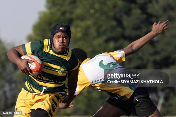 Sonwabo Buso from Soweto Jabulani Technical Secondary School U16 rugby runs with the ball during a match against Vryburger high school in...